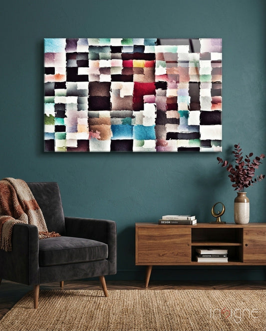 Abstract colorful glass wall art with pixelated blocks in muted tones displayed above wooden console in teal living room.