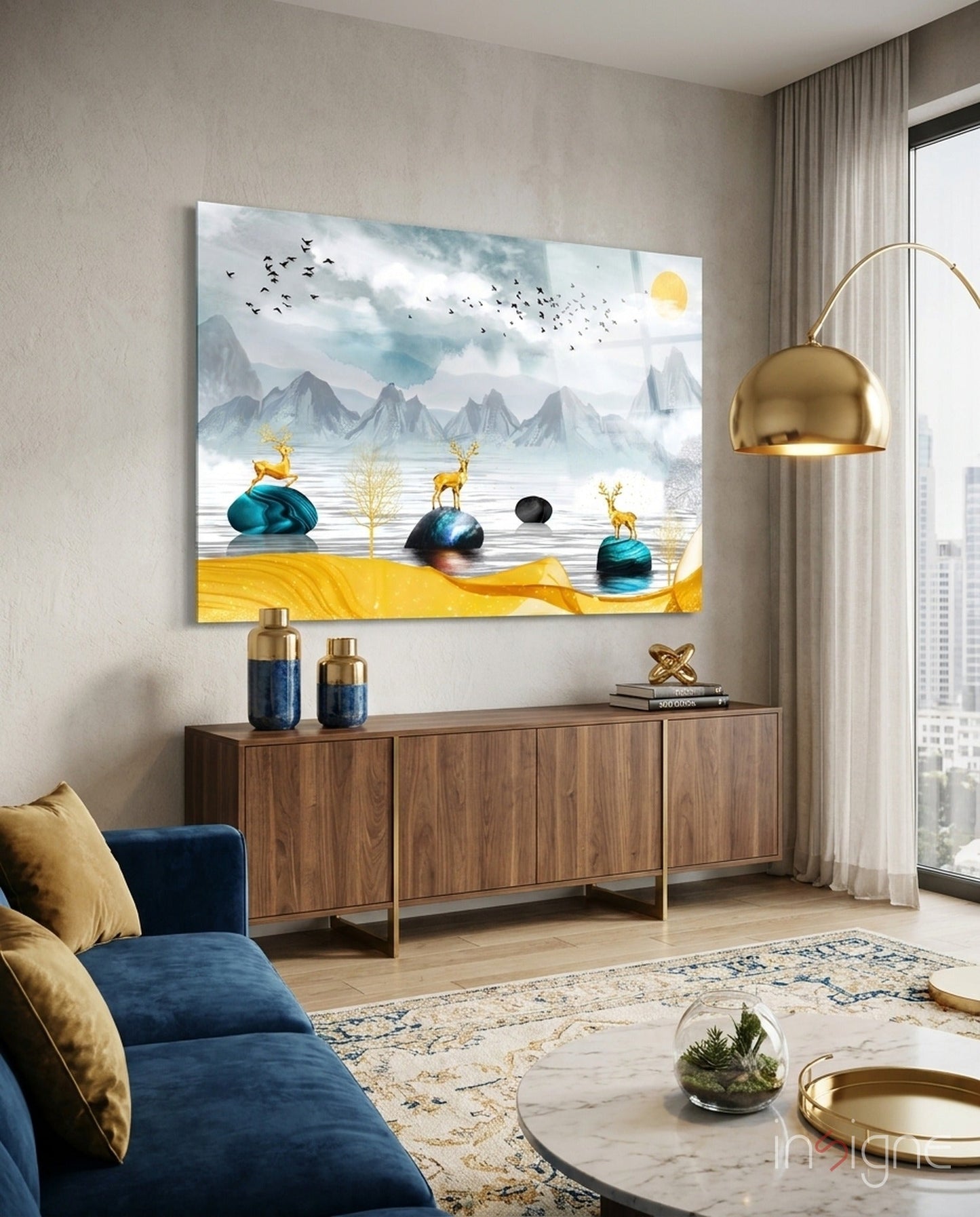 Glass wall art depicting golden deer on teal spheres beside a yellow sandy landscape with mountains and flying birds.