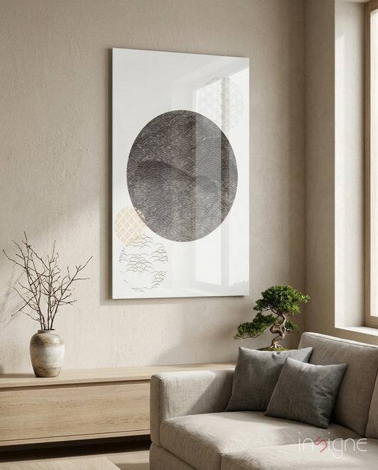 Black Moon Glass Wall Art displayed above a beige armchair in a minimalist room with dried branches and bonsai plant.