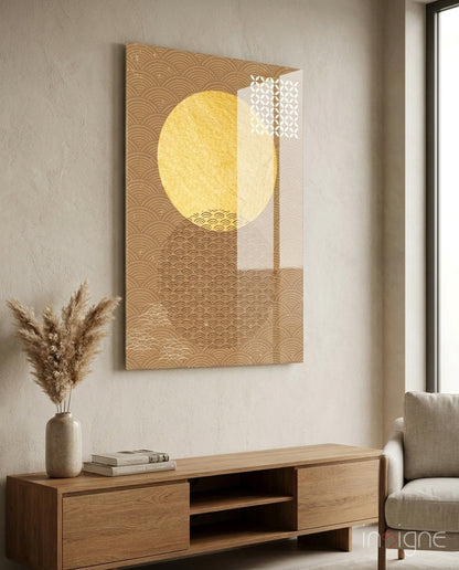Shadow of the Sun" glass wall art with golden geometric patterns and yellow circle displayed above wooden console table in minimalist interior.