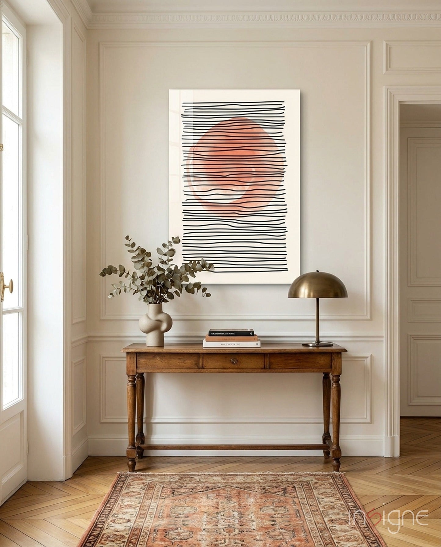 Abstract Sunset Glass Wall Art with black horizontal lines and coral-colored center hung above wooden console table in classical interior.