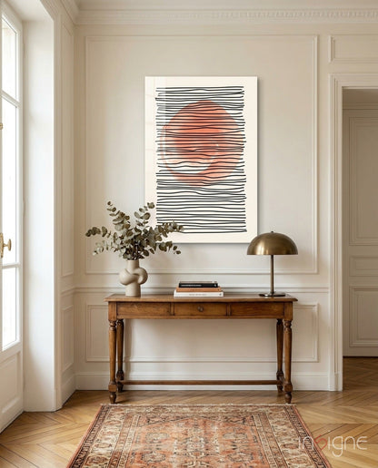 Abstract Sunset Glass Wall Art with black horizontal lines and coral-colored center hung above wooden console table in classical interior.