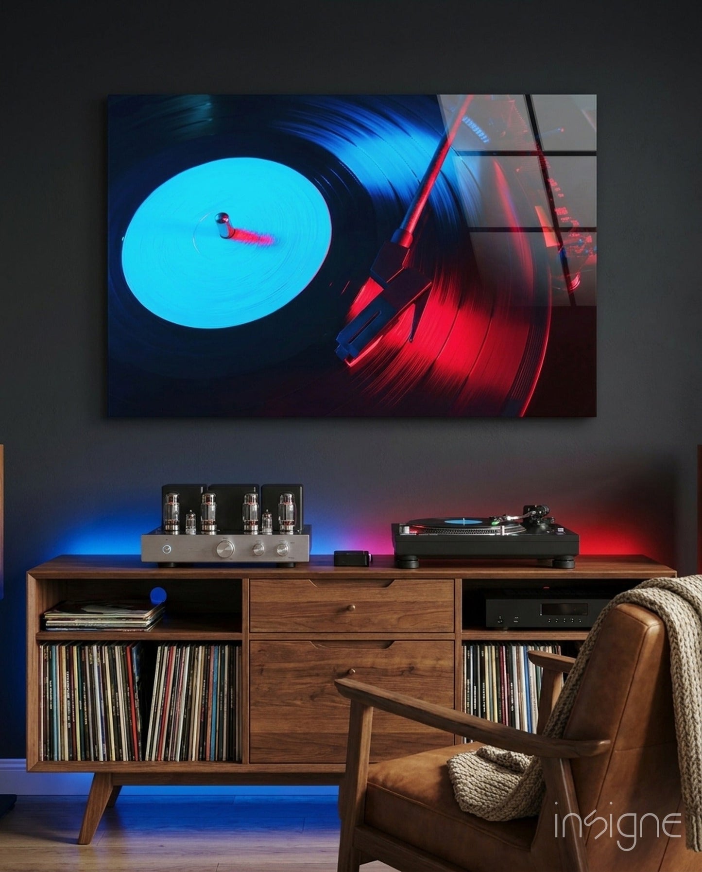 Gramophone glass wall art displaying glowing cyan vinyl record with red tonearm, mounted above wooden mid-century furniture in styled room setting.