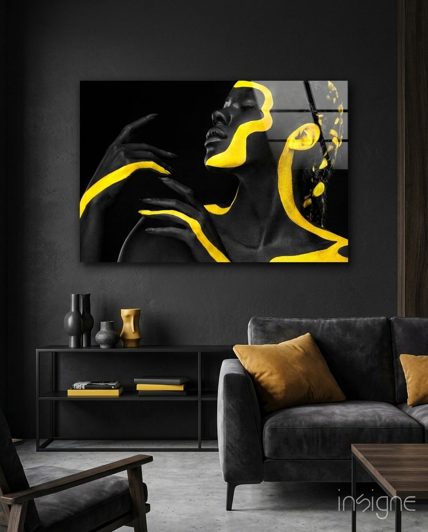 Yellow Woman Glass Wall Art displayed above a black cabinet in a modern living room with dark furnishings and gold accents.