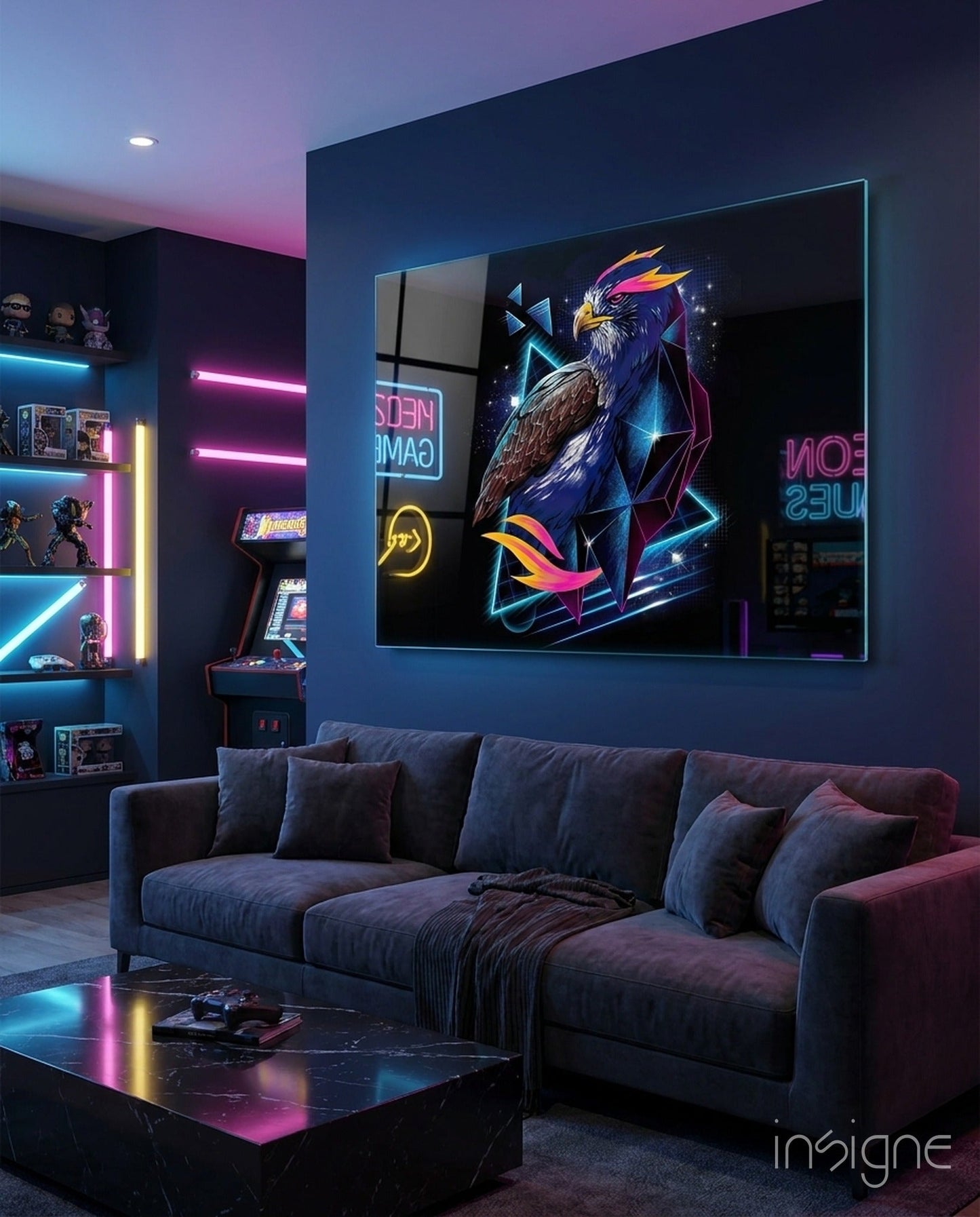 Diamond Hawk Glass Wall Art displaying neon-style eagle illustration mounted on dark blue wall above black sofa in gaming room.