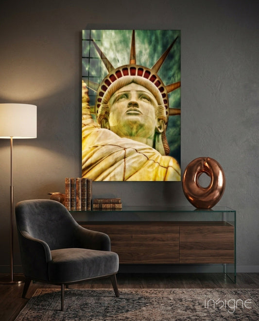 Statue of Liberty glass wall art displayed above a console table in a modern interior with chair and lamp.