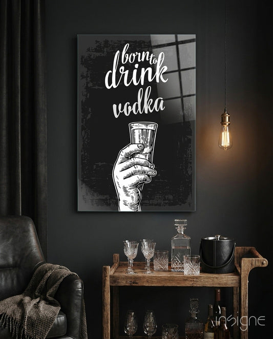 Black and white canvas featuring "born to drink vodka" text with illustrated hand holding glass, displayed above wooden bar cart with glassware.