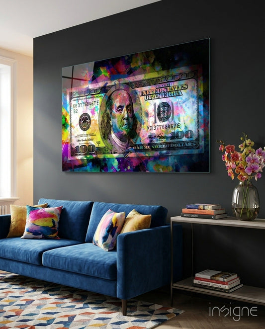 Colorful pop art glass wall art displaying a vibrant $100 bill with Benjamin Franklin portrait mounted above blue sofa.
