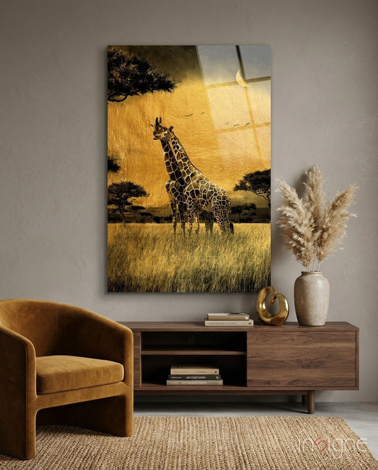 Glass wall art depicting a giraffe in golden grassland with acacia trees, displayed above a wooden console in a styled interior setting.