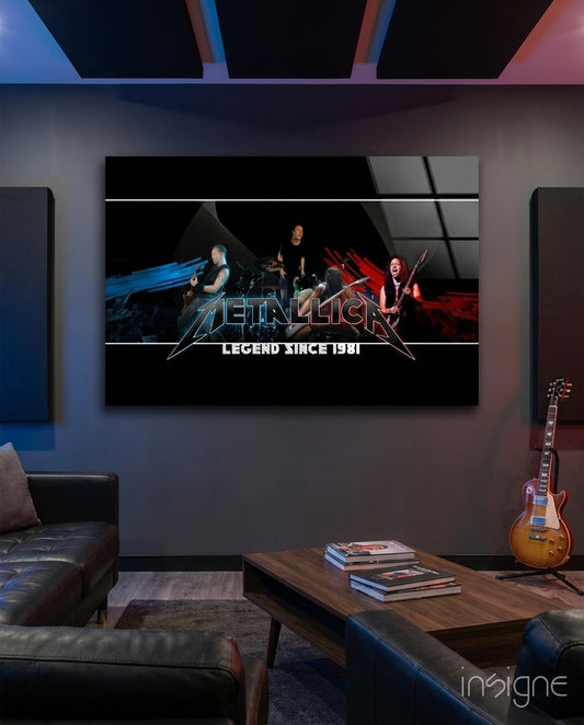 Metallica "Legend Since 1981" glass wall art displayed above wooden table in modern living room with leather seating and guitar.