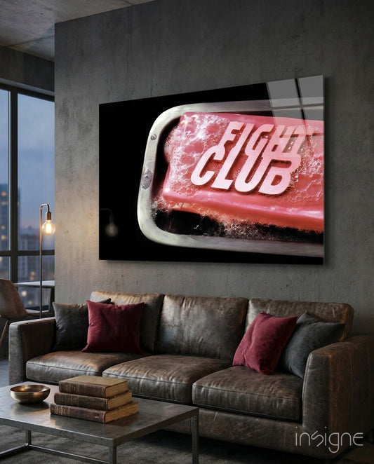 Fight Club glass wall art displaying red soap bar with white text mounted above brown leather sofa in modern loft interior.