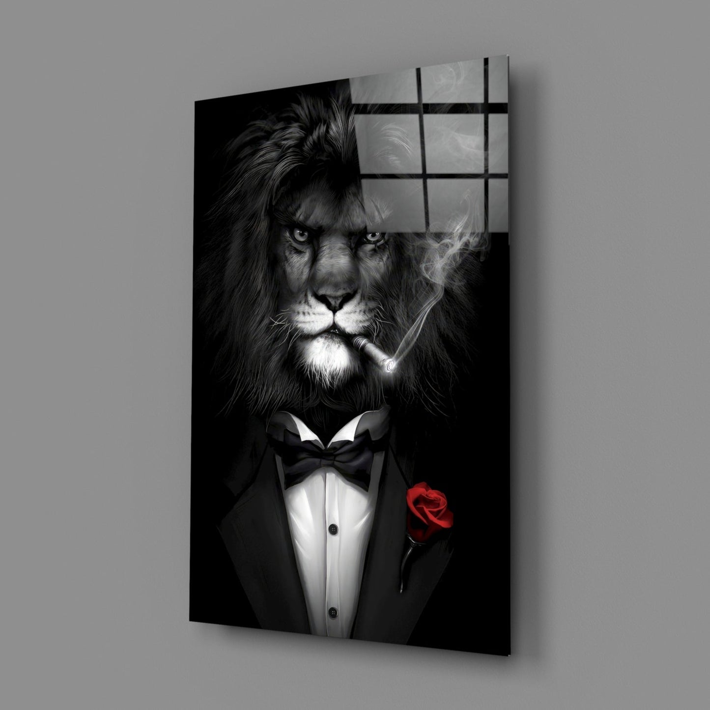Black and white glass wall art depicting a lion in formal tuxedo with bow tie and red rose, shown at angled perspective against gray background.