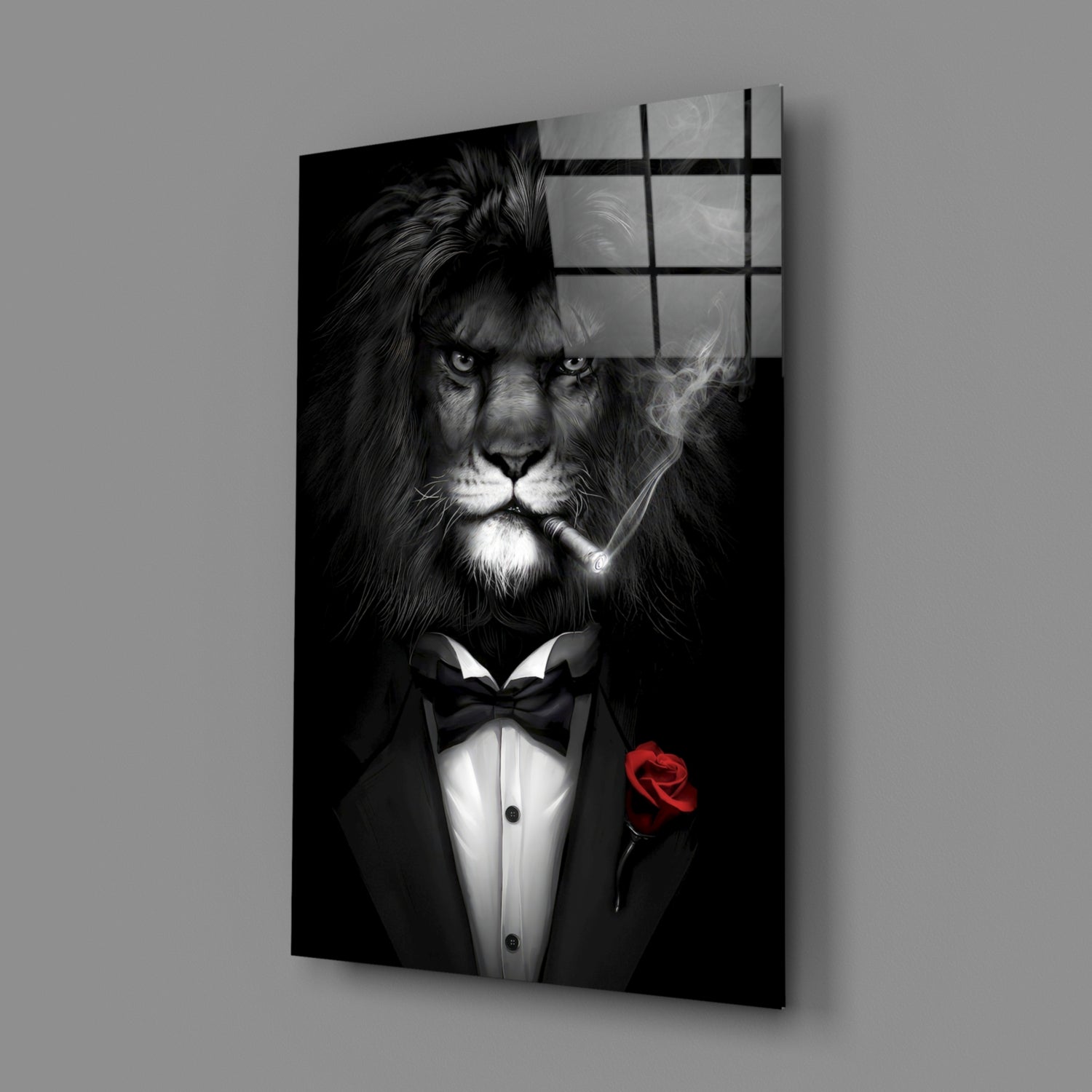 Black and white glass wall art depicting a lion in formal tuxedo with bow tie and red rose, shown at angled perspective against gray background.