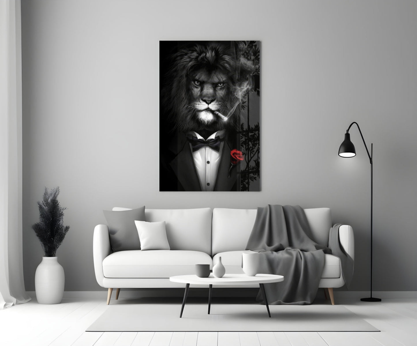 Black and white glass wall art of a lion wearing a tuxedo and bow tie with a red rose, displayed above a white sofa in a modern living room.