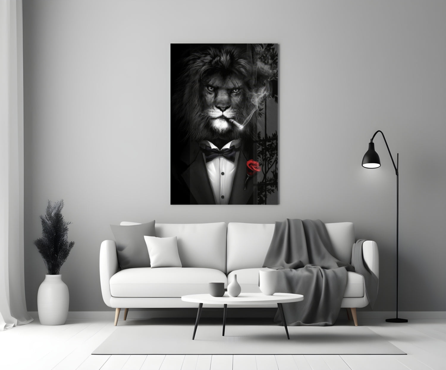 Black and white glass wall art of a lion wearing a tuxedo and bow tie with a red rose, displayed above a white sofa in a modern living room.