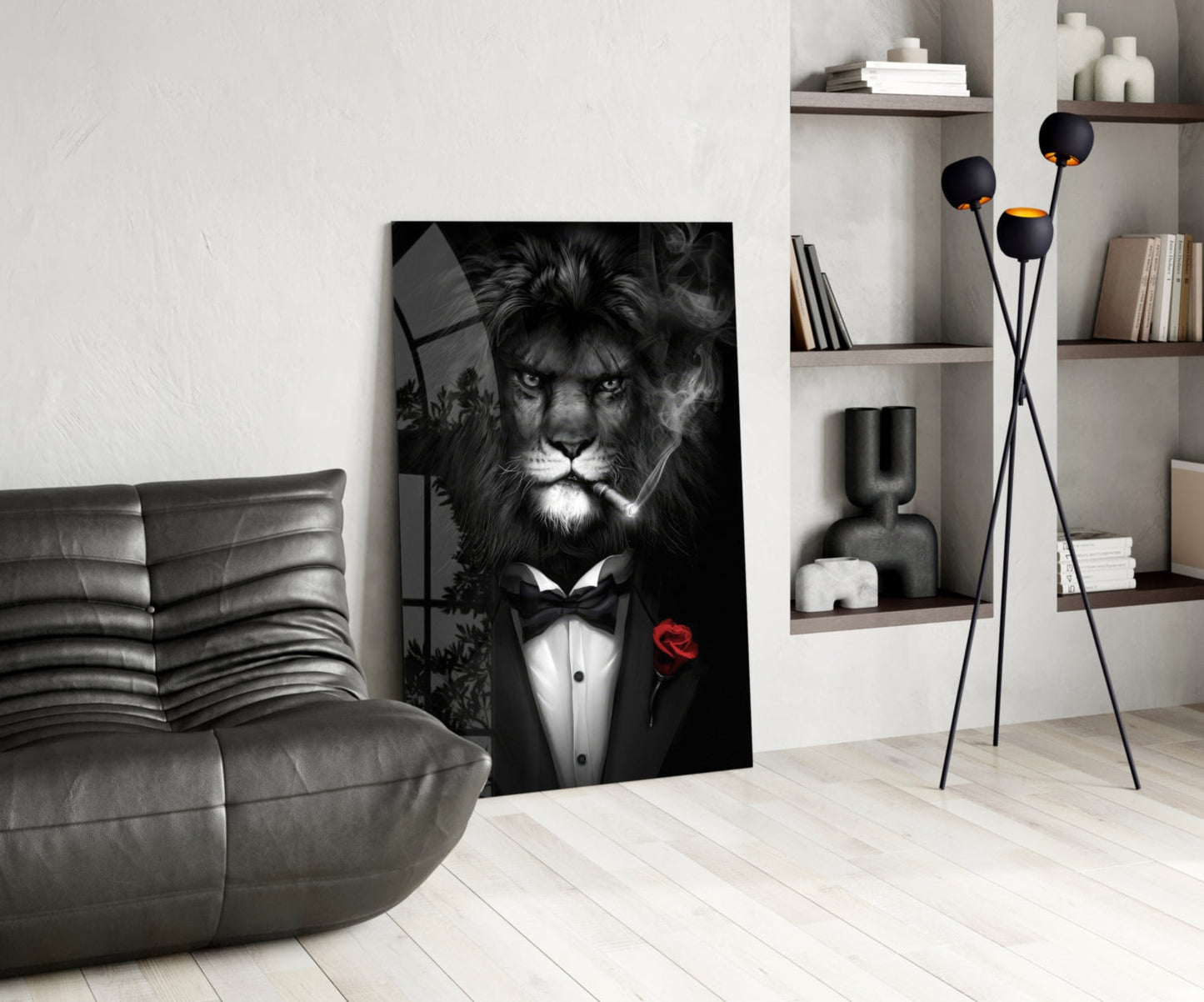 Black and white glass wall art of a lion in formal tuxedo with red rose displayed in modern living room setting.
