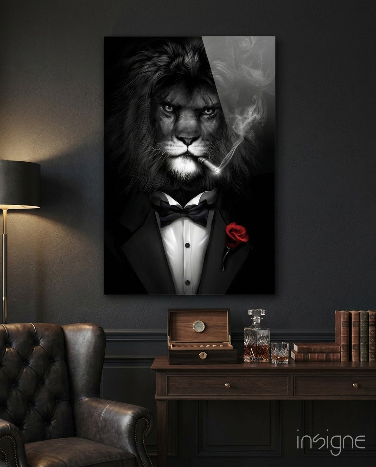 Black and white glass wall art depicting a lion in formal tuxedo with bow tie and red rose, displayed above a wooden desk in a study room.