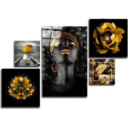Collection view of five glass wall art panels featuring gold accents on black and grayscale backgrounds with floral and portrait designs.