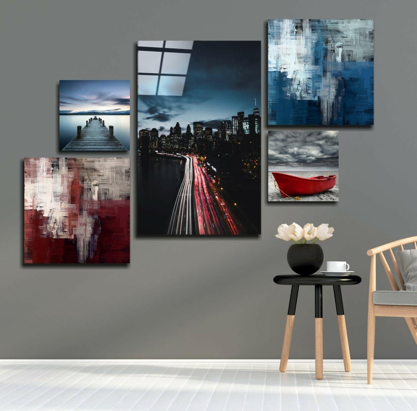Blue Serenity Combined Glass Wall Art displayed on gray wall above wooden chair with black side table and white flowers.