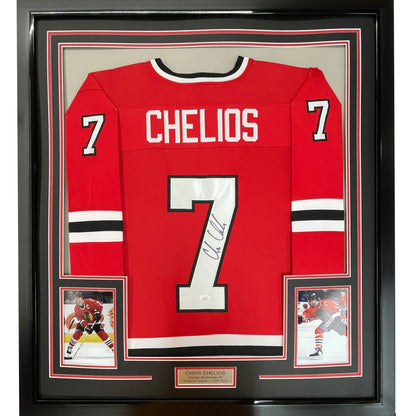 Framed red Chicago Blackhawks hockey jersey number 7 signed by Chris Chelios, displayed flat with two photographs and nameplate below.