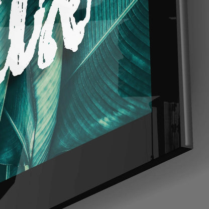 Angled side view of teal glass wall art displaying layered leaf design with white accents and striped texture detail.