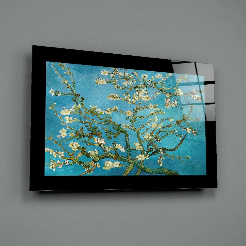 Black-framed glass wall art displaying Van Gogh's almond blossoms painting with turquoise background and white flowers, mounted on gray wall.