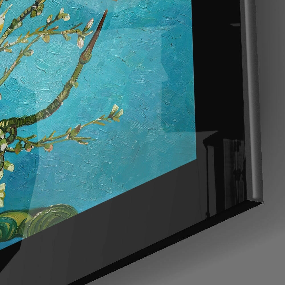 Close-up angled view of framed glass wall art displaying turquoise background with golden almond branches and blossoms.