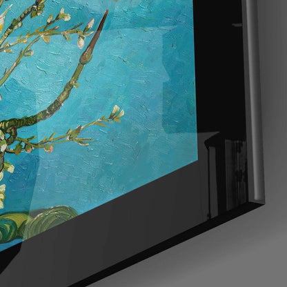 Close-up angled view of framed glass wall art displaying turquoise background with golden almond branches and blossoms.