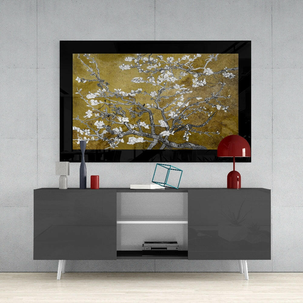 Gold Almond Flowers glass art displayed above a gray media console with white legs in a modern living room setting.