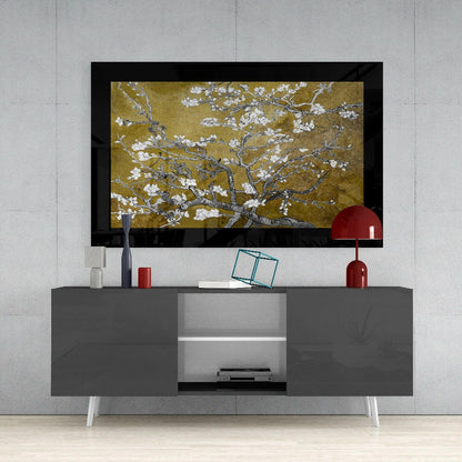 Gold Almond Flowers glass art displayed above a gray media console with white legs in a modern living room setting.