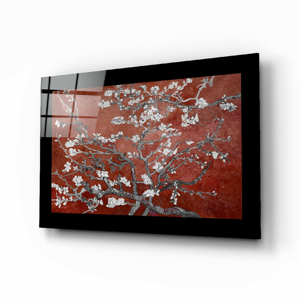 Black-framed glass wall art displaying white flowering branches on deep red background, mounted at angle showing depth and dimension.