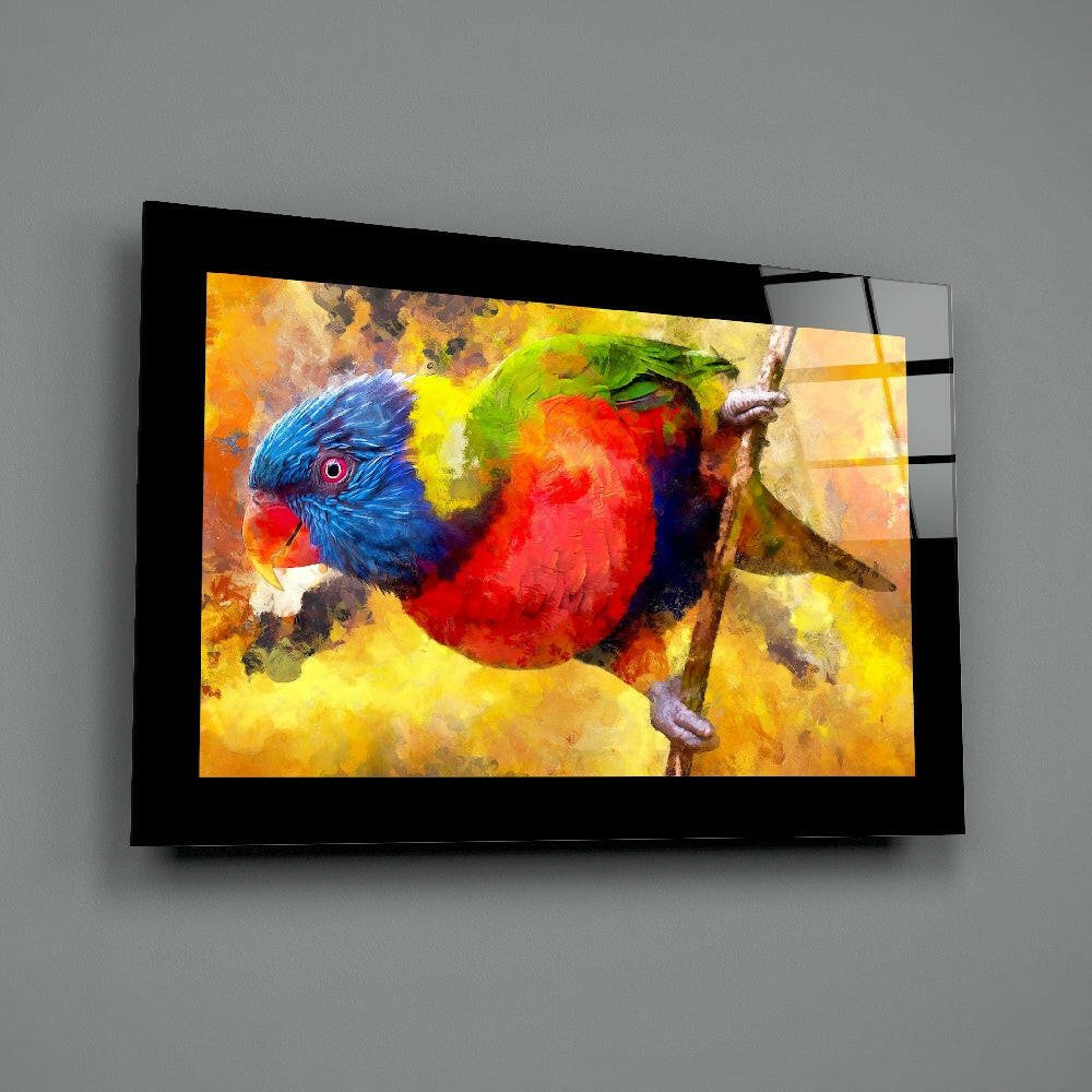 Black-framed glass wall art displaying a vibrant watercolor-style rainbow lorikeet perched on a branch against warm yellow and orange tones.