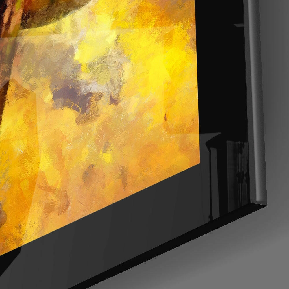 Close-up angled view of tropical parrot glass wall art displaying vibrant yellow and orange feather tones mounted on black frame.
