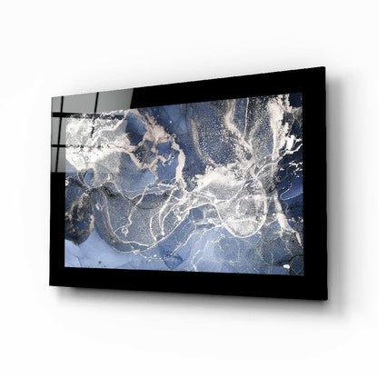 Black-framed blue quartz glass wall art mounted on white wall, displaying satellite or aerial map view with white cloud patterns and blue water.