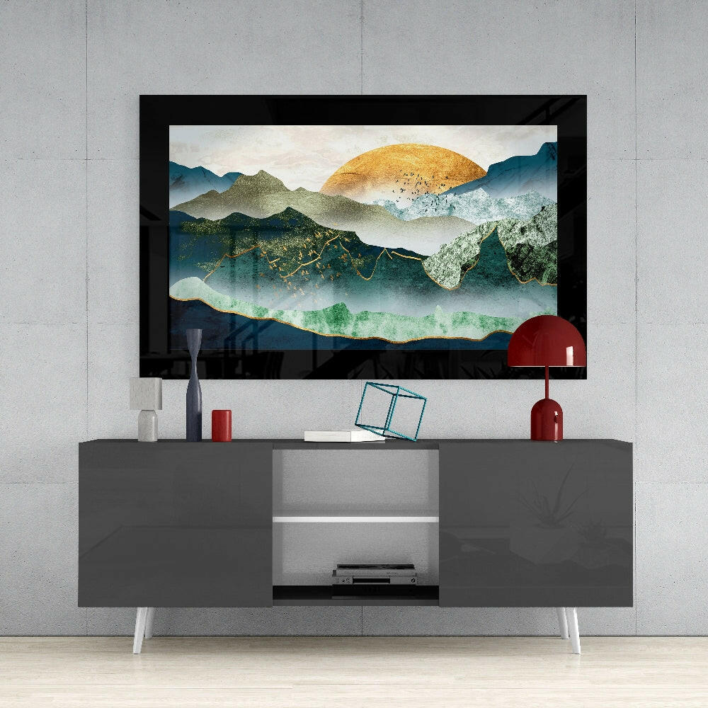 Emerald Valley Glass Wall Art mounted above gray TV console, showing layered mountain landscape with golden sun and teal-green valley against concrete wall.