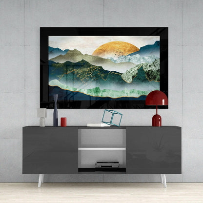 Emerald Valley Glass Wall Art mounted above gray TV console, showing layered mountain landscape with golden sun and teal-green valley against concrete wall.