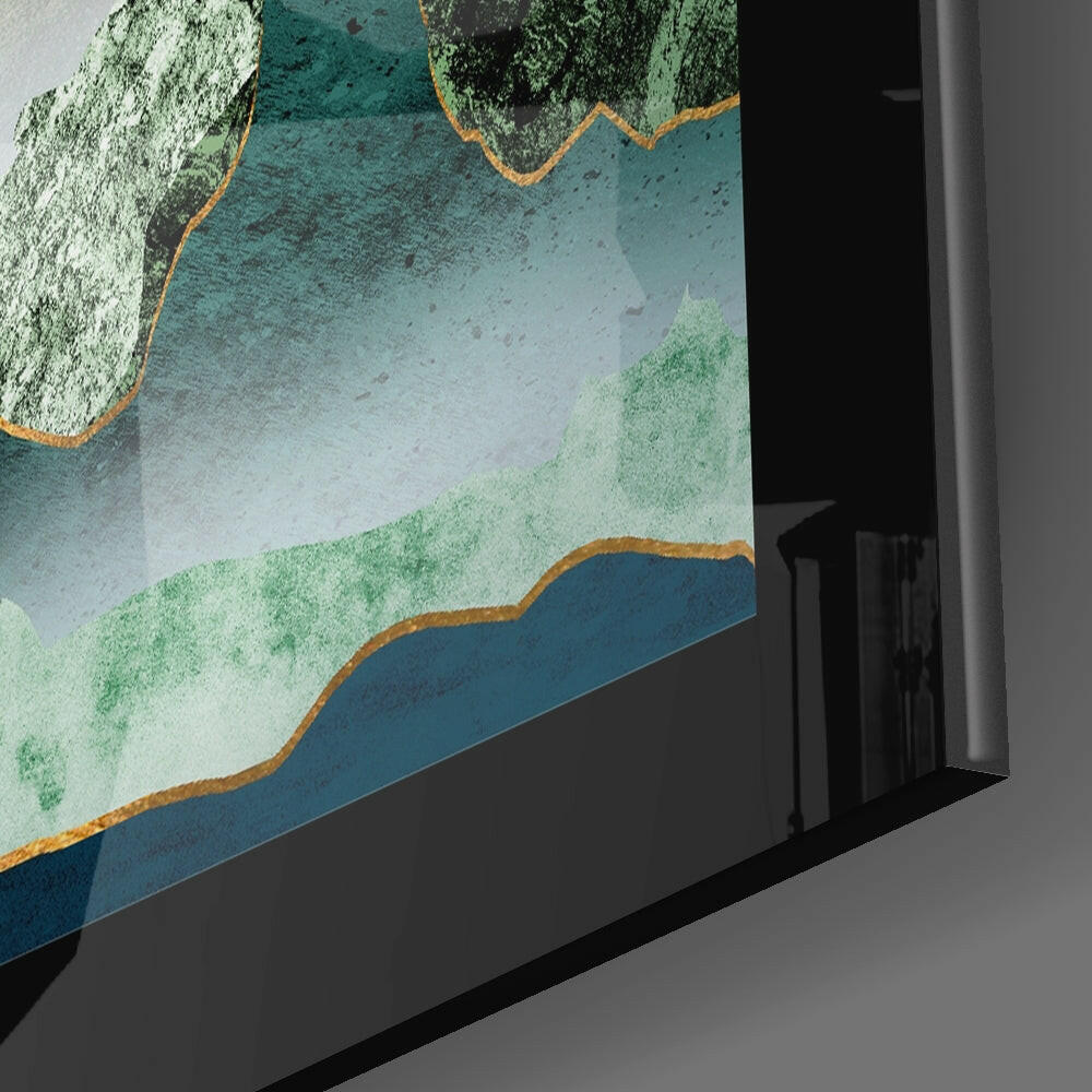 Angled side view of Emerald Valley Glass Wall Art showing textured landscape with teal water, green moss, and gold-outlined boundaries on black frame.