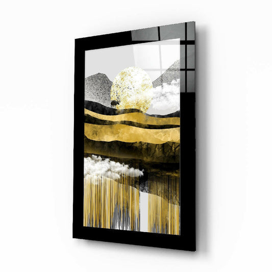 Black-framed glass wall art displaying an abstract landscape with gold leaf, mountains, and a silhouetted tree against textured gray and white layers.