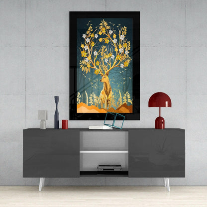 Golden deer with flowering tree branches in black frame displayed above gray media console with red lamp and decorative accessories.
