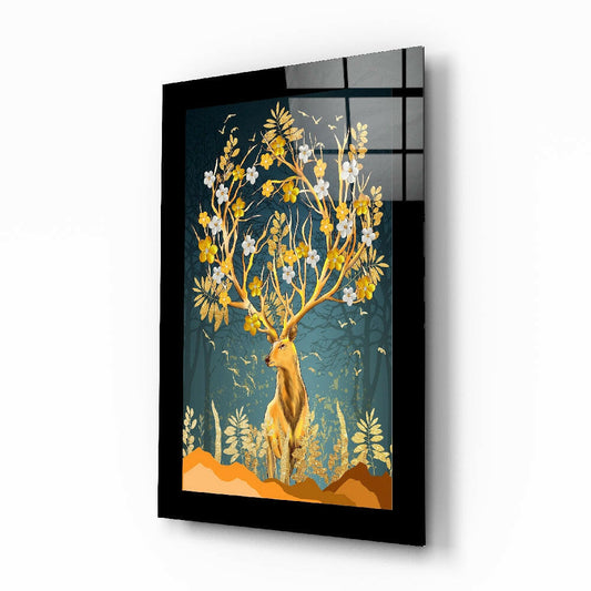 Black-framed glass wall art displaying a golden deer with flowering branches against a teal background, angled three-quarter view.