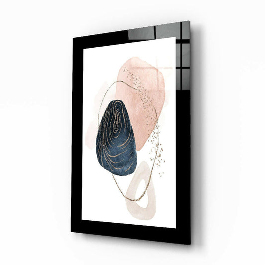 Framed glass wall art displayed at an angle showing navy concentric circles, blush pink and cream watercolor shapes with gold line details on white background.