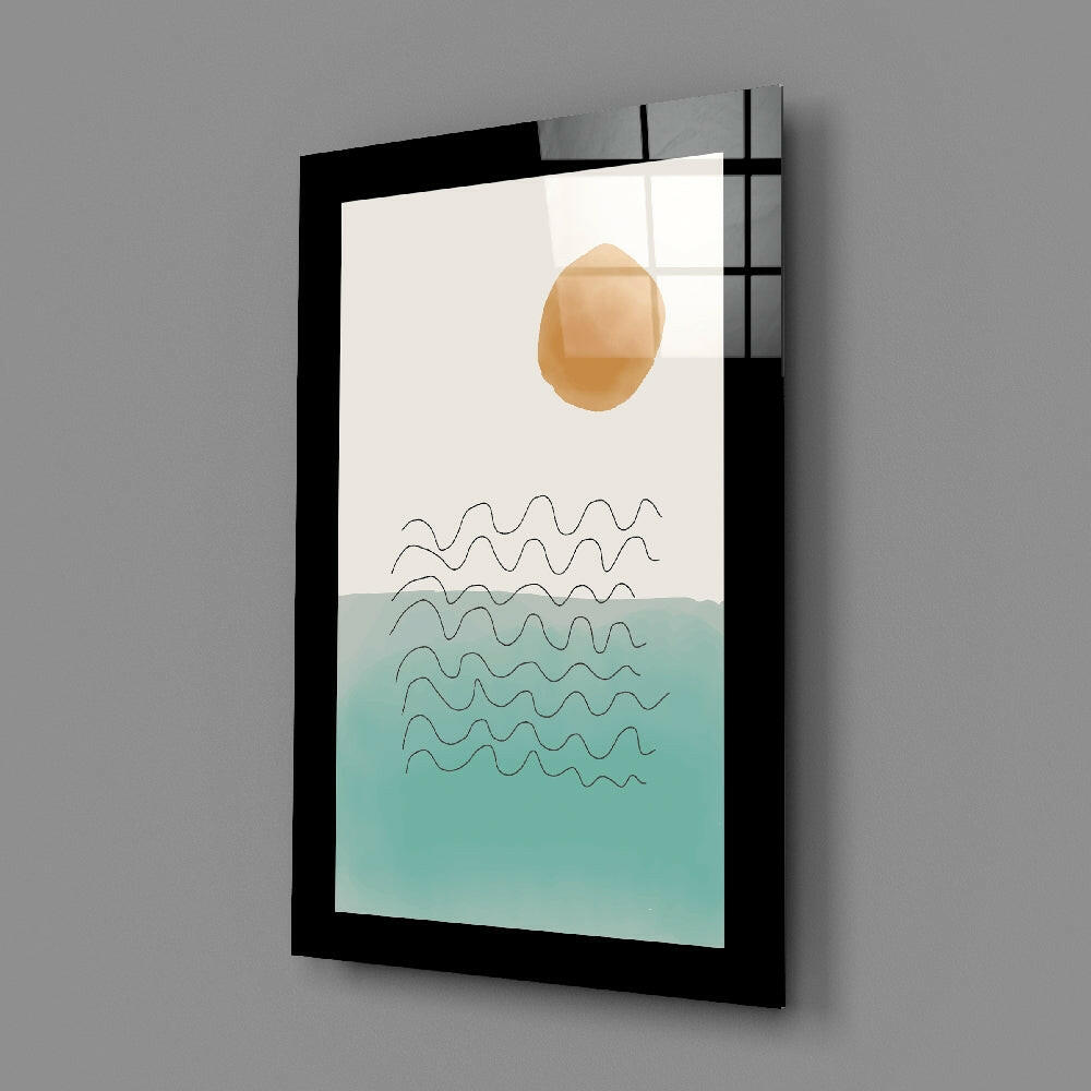 Black-framed glass wall art displaying a peach sun, wavy lines, and turquoise water gradient on white background, angled view.