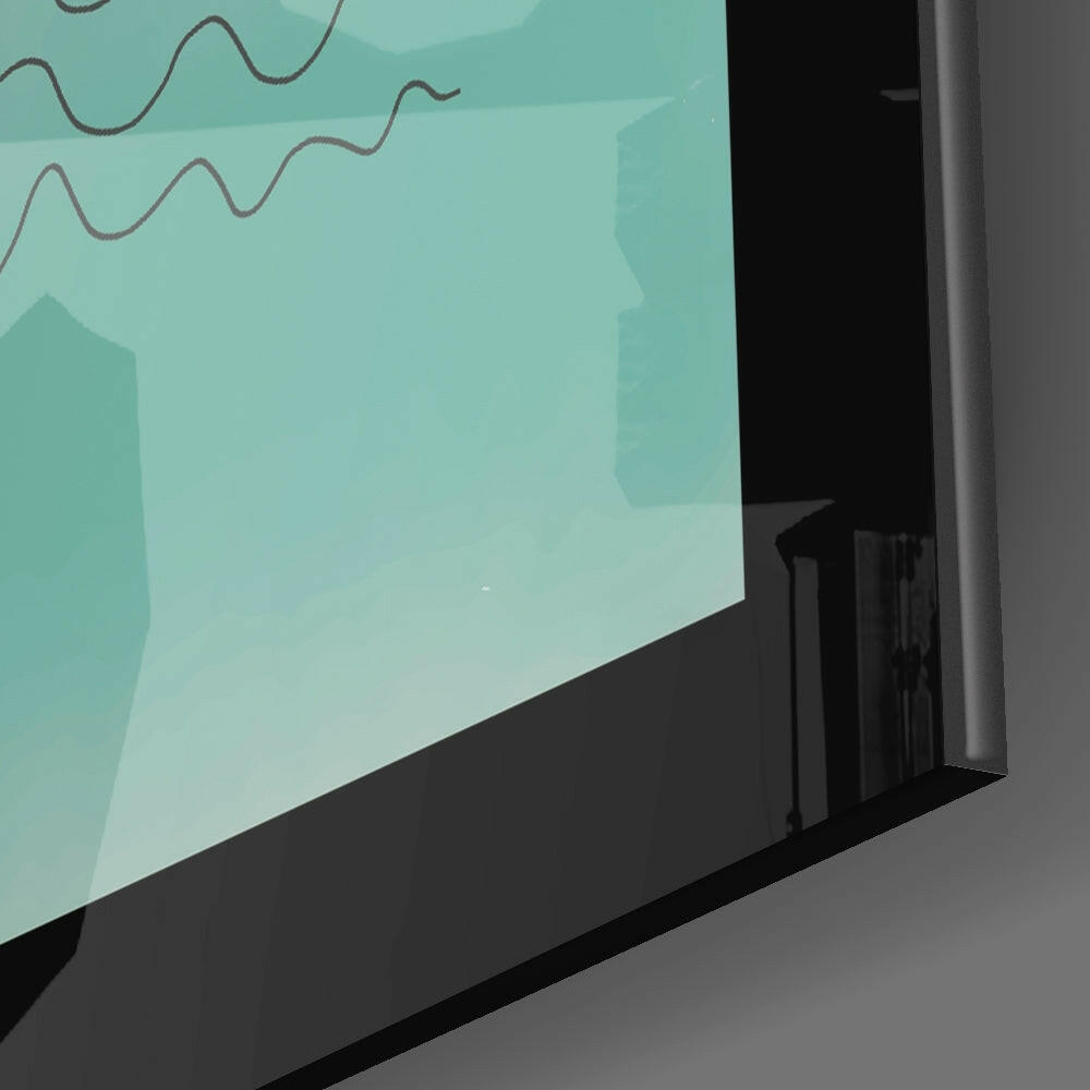 Angled side view of framed turquoise glass wall art with wavy line design displayed on gray surface.