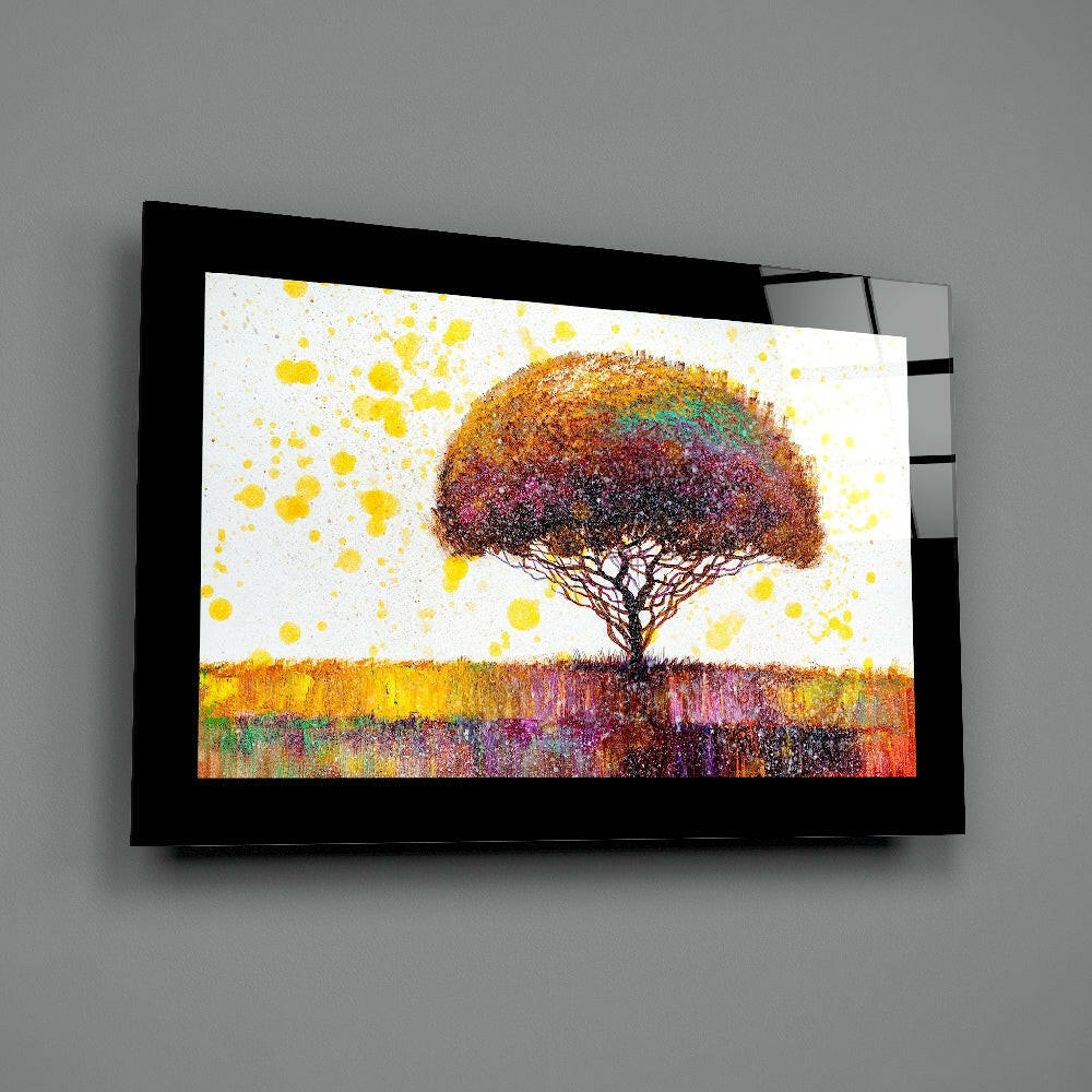 Black-framed glass wall art displaying a colorful tree with rainbow canopy above a textured landscape with yellow accents.