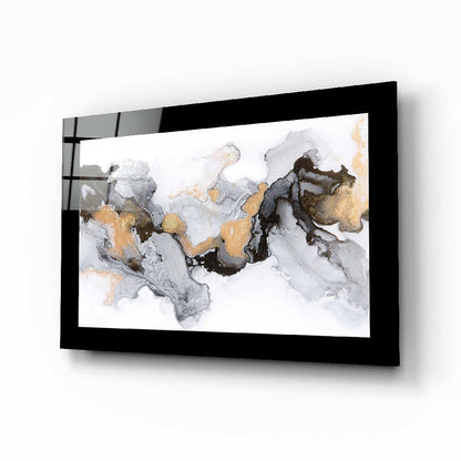 Black-framed glass wall art displaying abstract marble pattern with gray, white, and gold swirled design, mounted at angle.