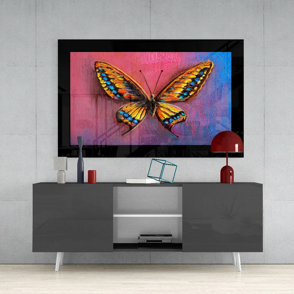 Colorful butterfly glass wall art displayed above a gray media console in a modern living room setting.