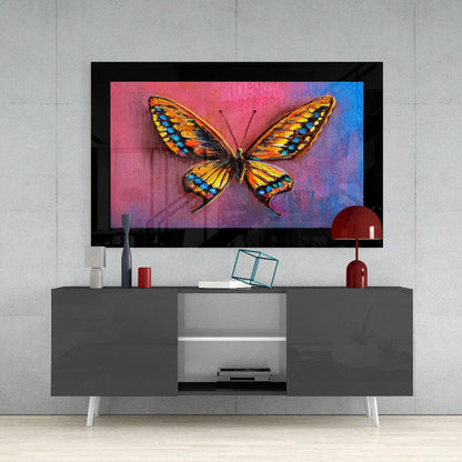 Colorful butterfly glass wall art displayed above a gray media console in a modern living room setting.