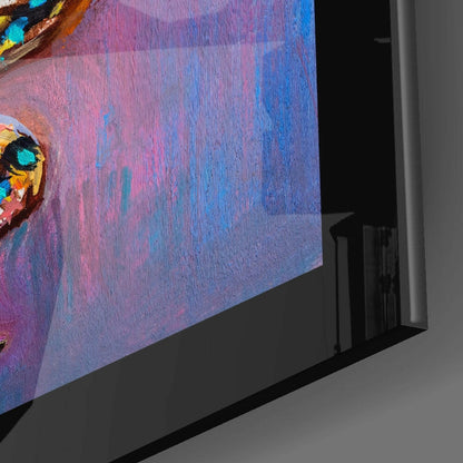 Close-up angled view of glass wall art showing vibrant purple, blue, and pink gradient background with colorful butterfly detail in upper left corner.