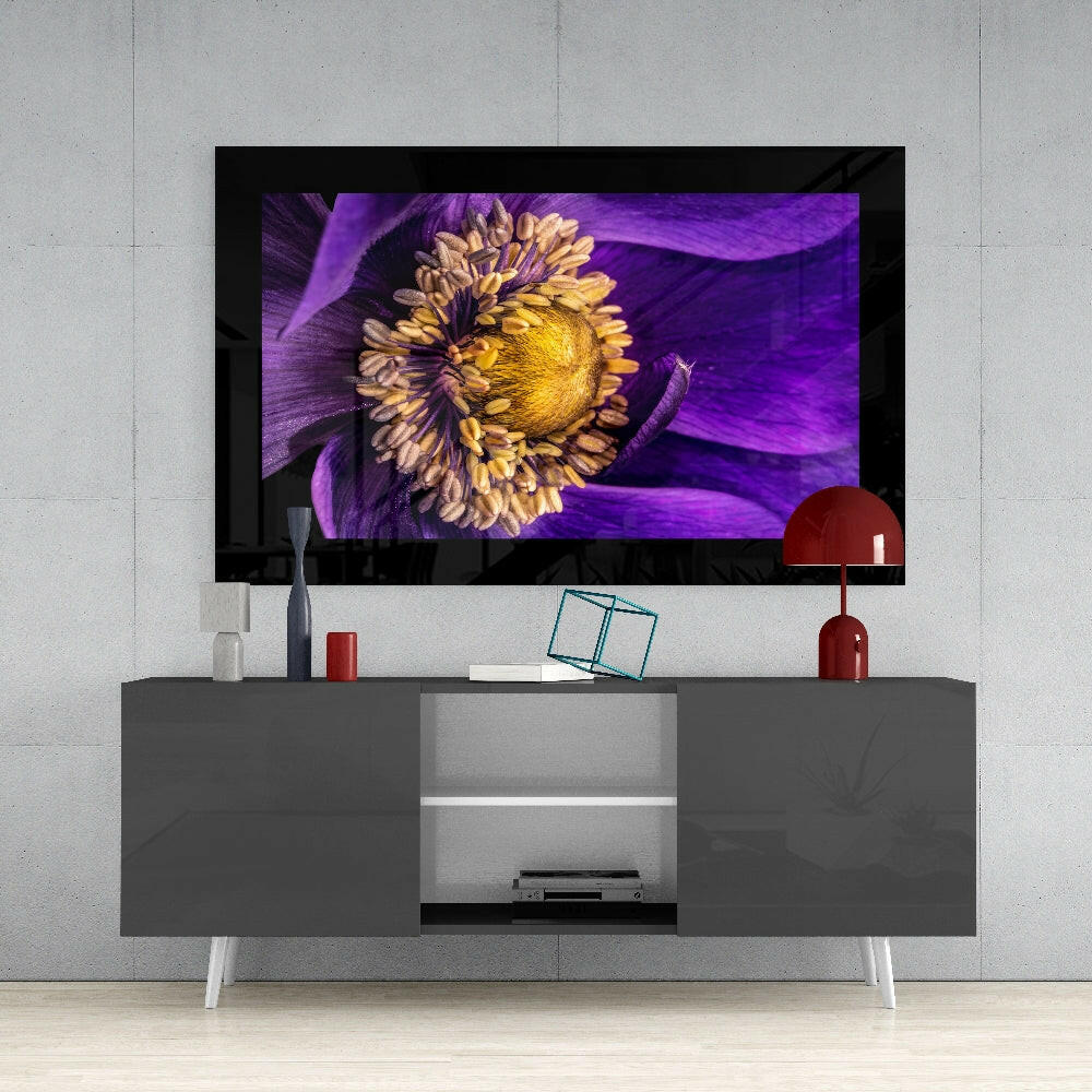 Modern living room setup displaying passionflower glass wall art on mounted TV above gray media console with red accents.
