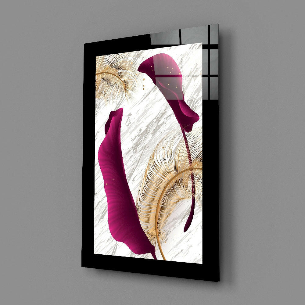 Black-framed glass wall art displaying purple leaf shapes and gold botanical details against white marble background, angled perspective view.